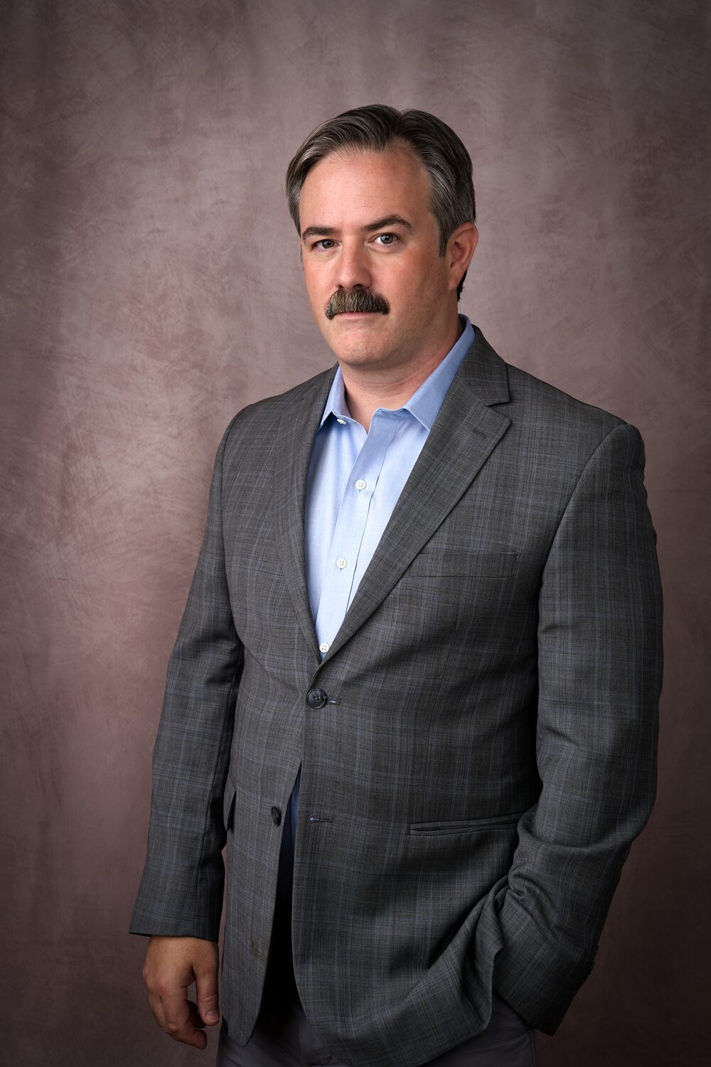 Guy Olivieri in a gray suit